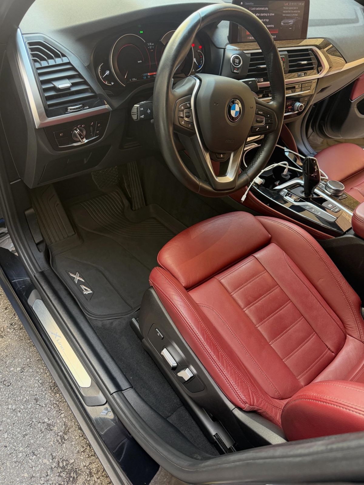 BMW X4 driver side with red leather seat after interior detail