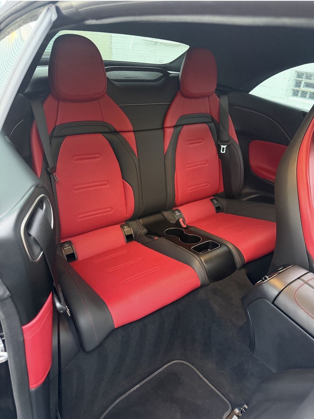 Red and black rear seats in a Mercedes-AMG coupe