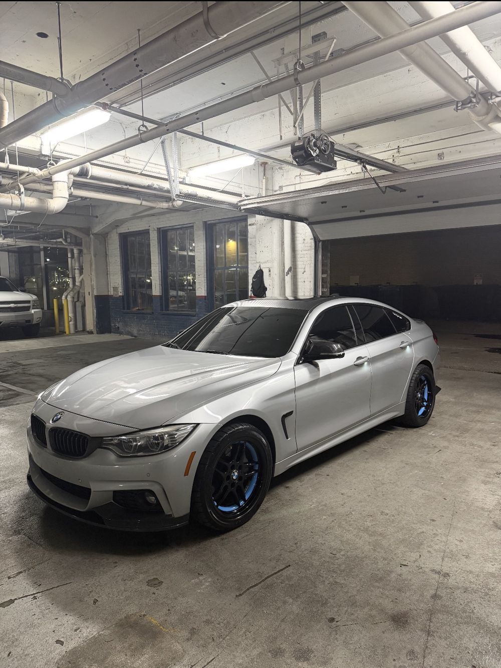 Silver BMW 4 Series in a parking garage after detailing