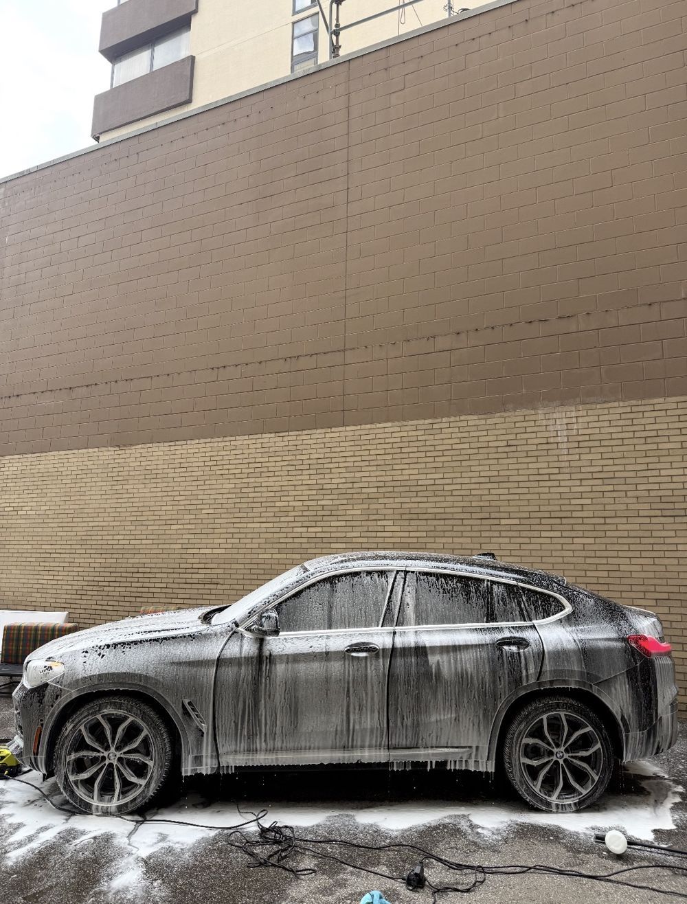 BMW X4 covered in foam during a hand wash