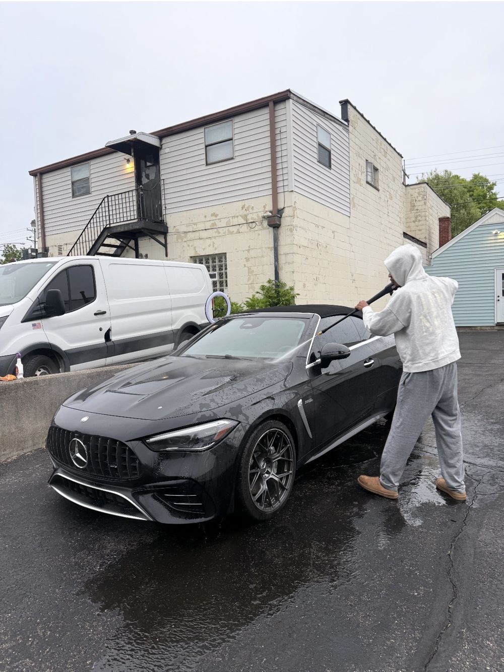 LED Detailing hand washing a black Mercedes-AMG convertible